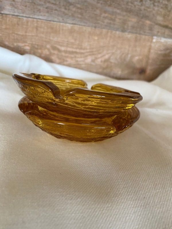 Vintage amber glass ashtrays set close