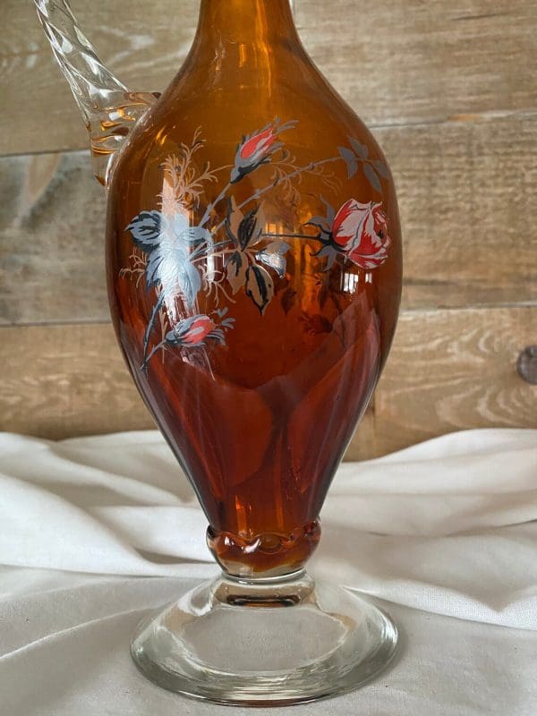 vintage amber glass decanter close of clear pedestal base