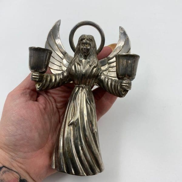 silver angel candle holder in hand