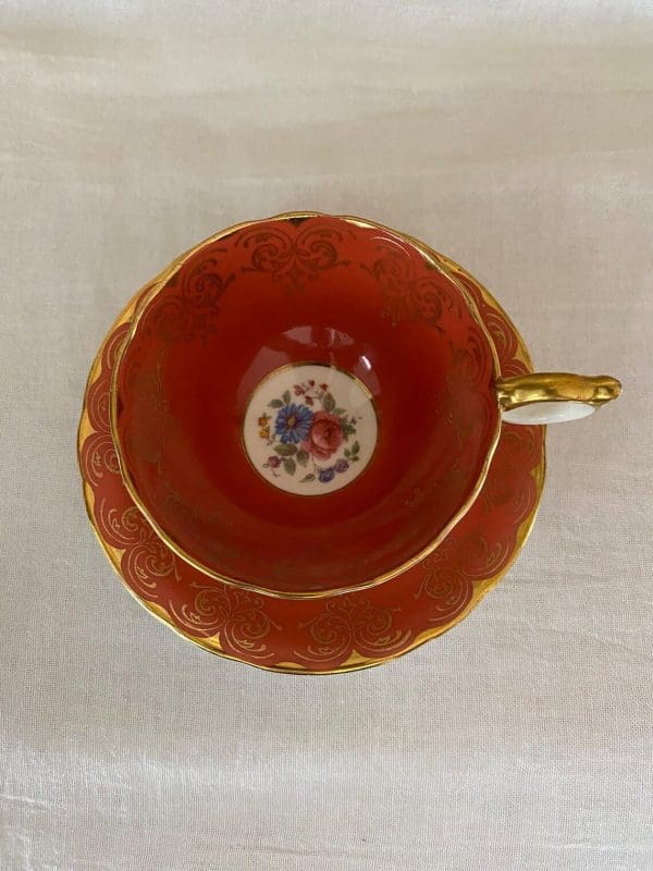 Aynsley bone china tea cup in burnt orange, gold trim and floral