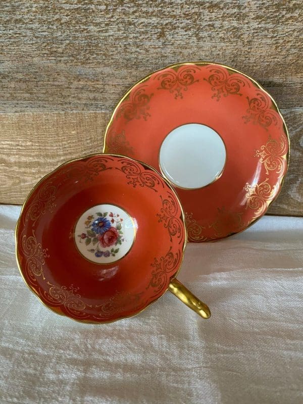 Aynsley bone china tea cup in burnt orange, gold trim and floral side view