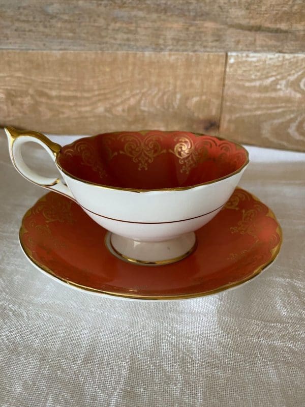 Aynsley bone china tea cup in burnt orange, white, gold trim and floral side 3