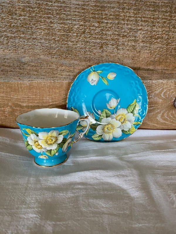 Aynsley England bone china tea cup 1930s in blue and yellow with flower showing tea cup and saucer