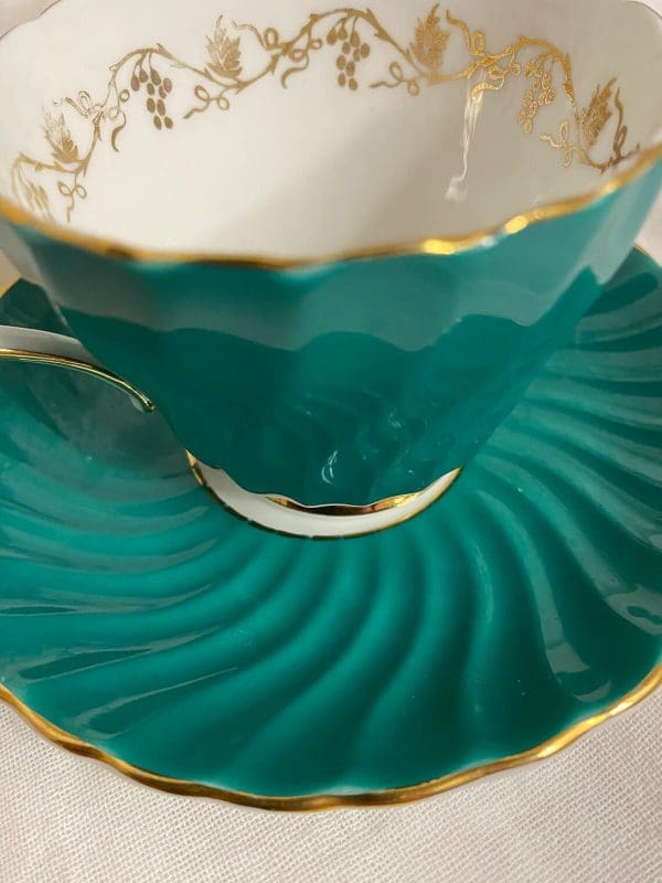 Aynsley tea cup and saucer green and gold 1950s closeup