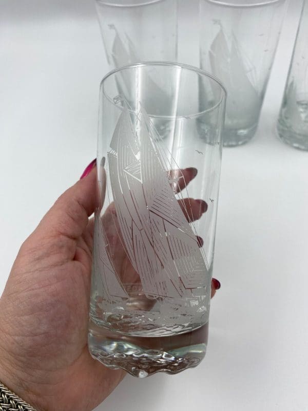 nautical drinking glasses in hand showing ship etching