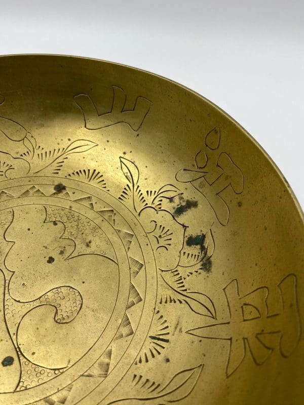 Chinese brass dragon bowl close showing embossed detail and some patina