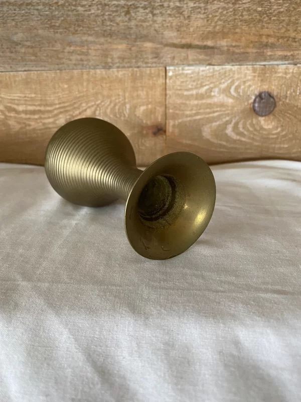 brass flower vase on side