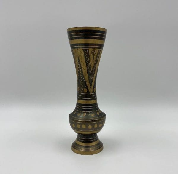 black and brass vase close side