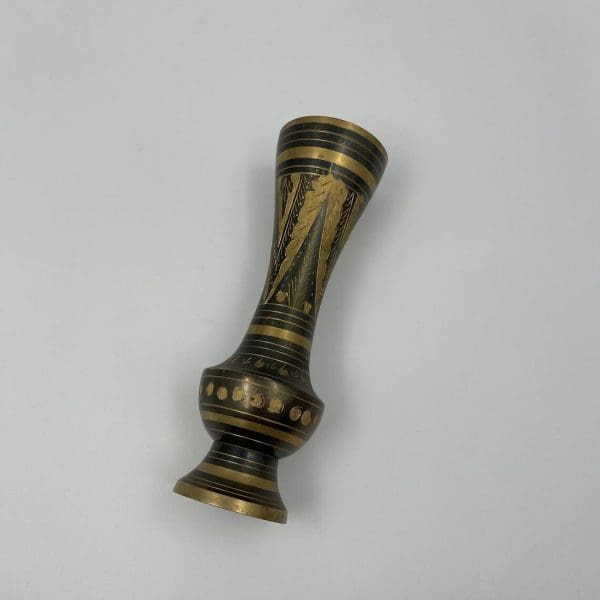 black and brass vase on side