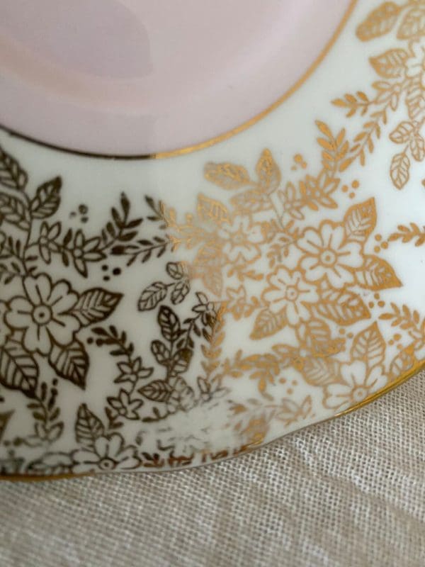 Colclough china tea cup pink, white and gold floral closeup of trim