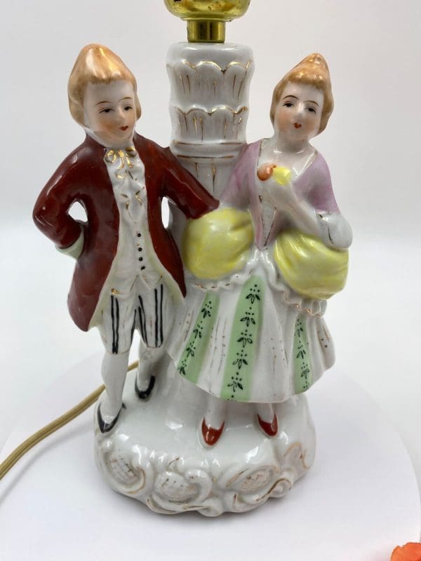 vintage porcelain figurine lamps close of man and woman dressed in colonial clothing