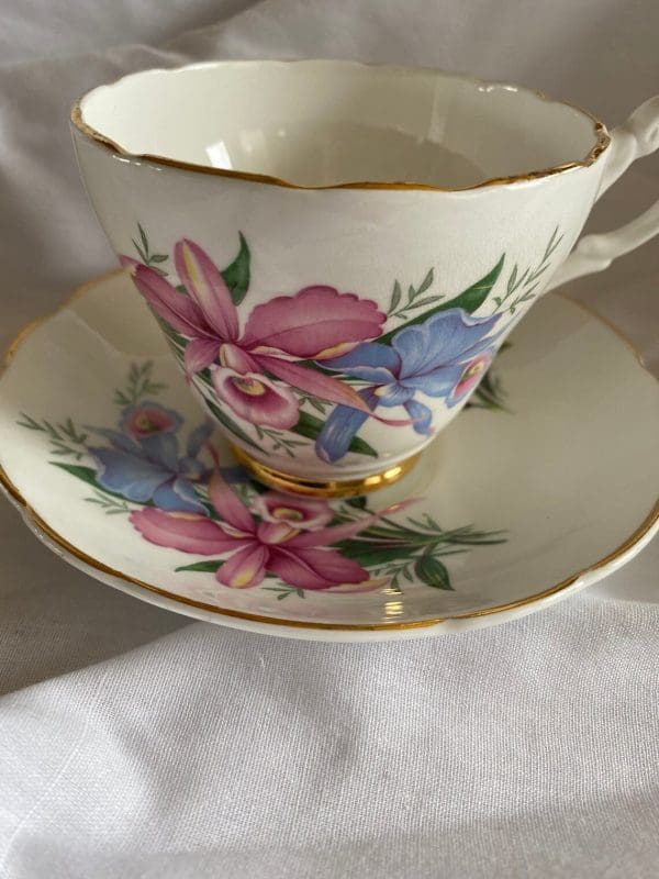 Consort tea cup with flowers design pink and blue daffodils gold trim closeup