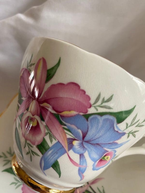 Consort tea cup with flowers design pink and blue daffodils close up