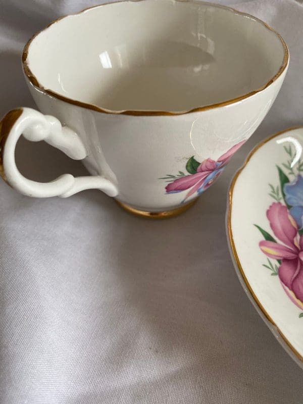 Consort tea cup with flowers design pink and blue daffodils gold trim. closeup three