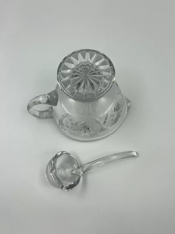 crystal gravy boat bottom of boat and ladle beside