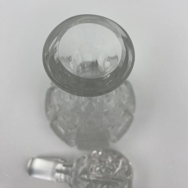 small crystal decanter top of bottle