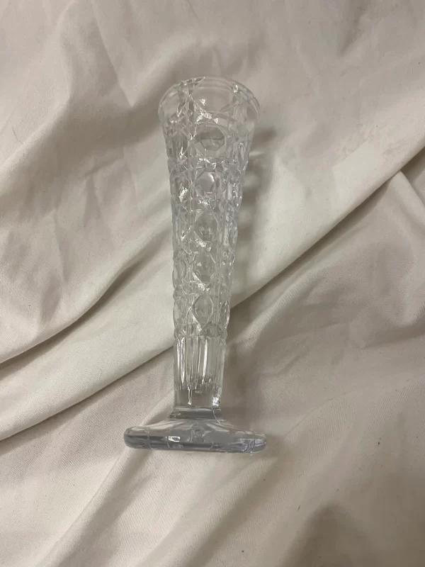 vintage cut glass bud vase laying on side