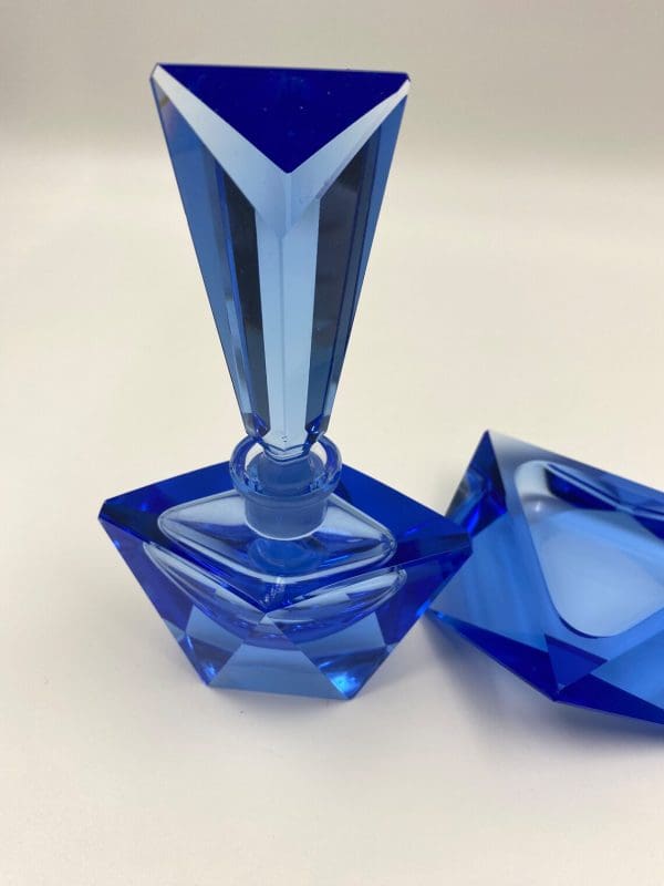 blue crystal perfume bottle close to front of bottle