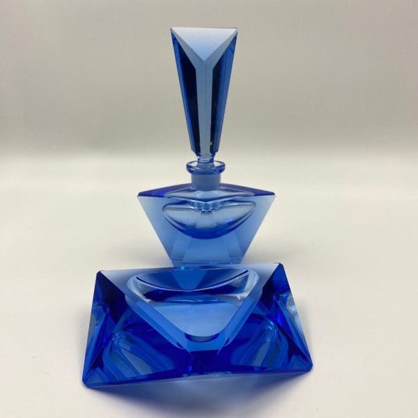 blue crystal perfume bottle close of trinket dish