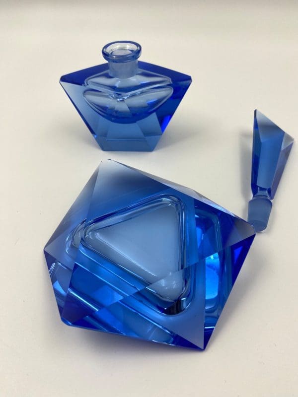 blue crystal perfume bottle bottom of trinket dish stopper out of bottle