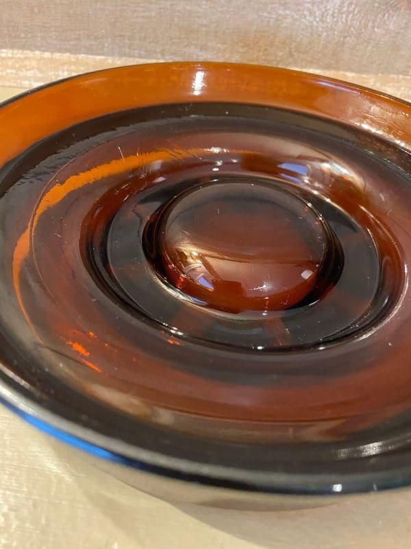 Vintage glass cigar ashtray dark amber, round bottom close