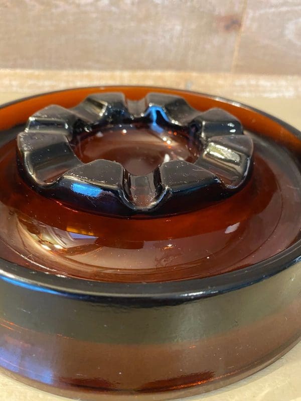 Vintage glass cigar ashtray dark amber, round close up