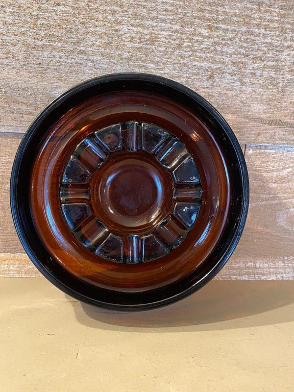 Vintage glass cigar ashtray dark amber, round standing view