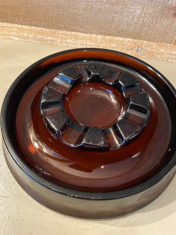 Vintage glass cigar ashtray dark amber, round top down view