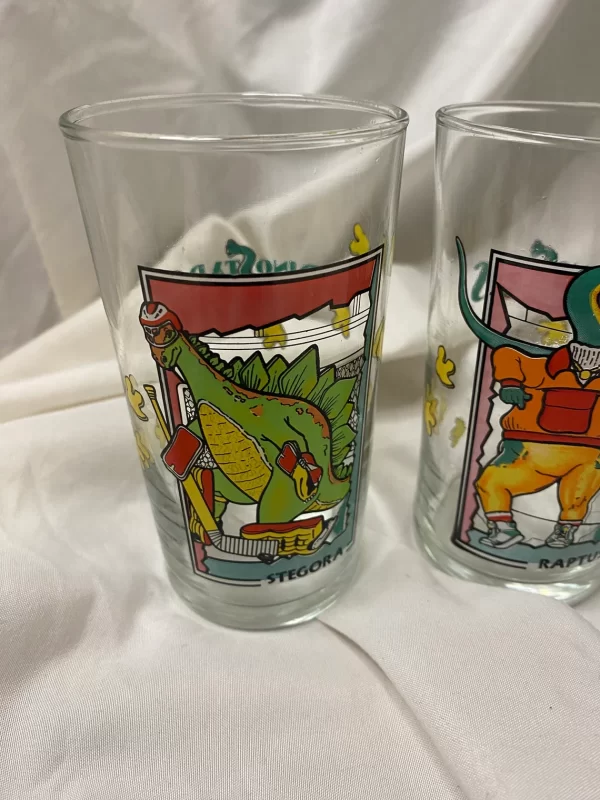 dinosaur drinking glasses front of one