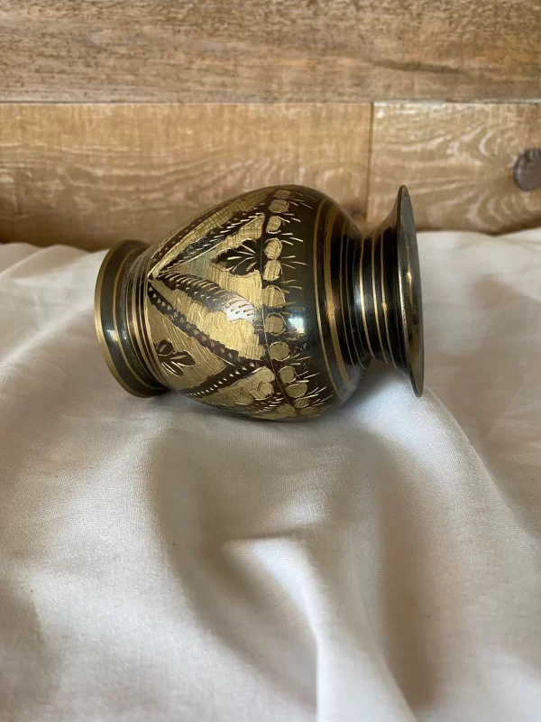 etched brass vase from India laying on side