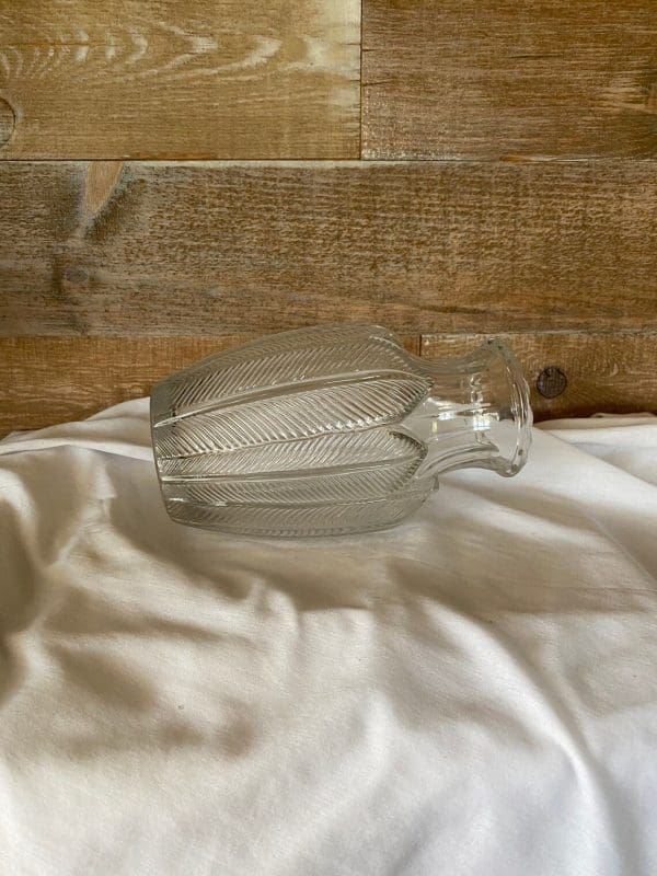 vintage clear glass vases laying on side