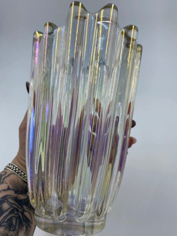 iridescent glass vase in hand