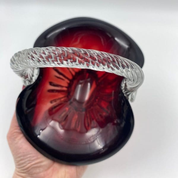 ruby red glass basket in hand to show size