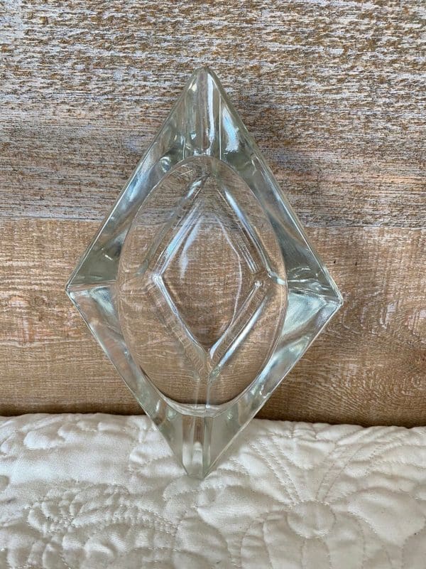 diamond shaped glass ashtray standing on end