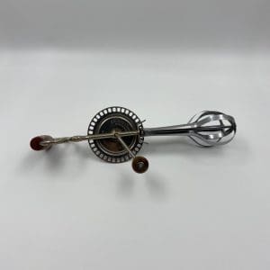 vintage egg beater on side with Bakelite handle and turning knob