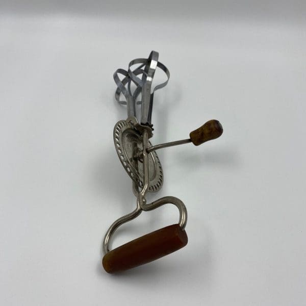 vintage egg beater close of Bakelite handle