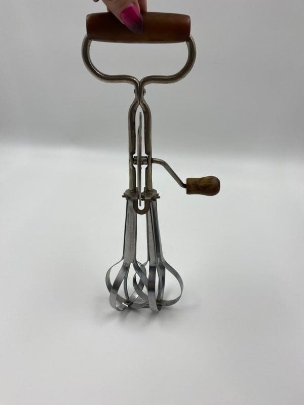 vintage egg beater held upright