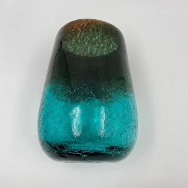 green crackle glass vase on side