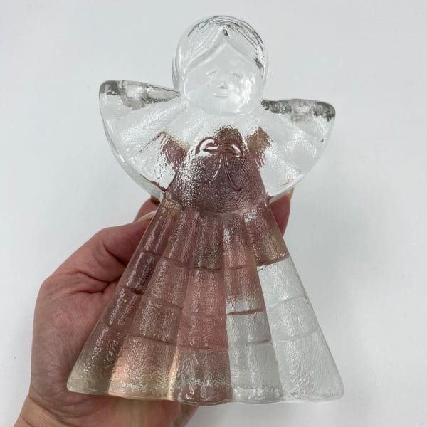 glass angel candle holder in hand to show size comparison