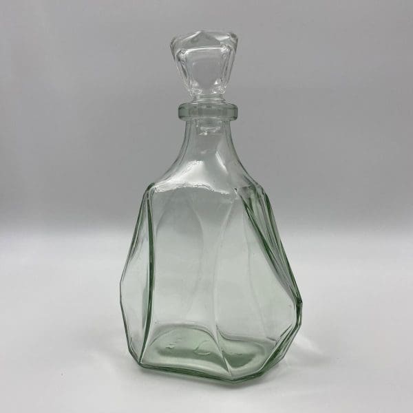 vintage whiskey decanter close showing the green tinted glass