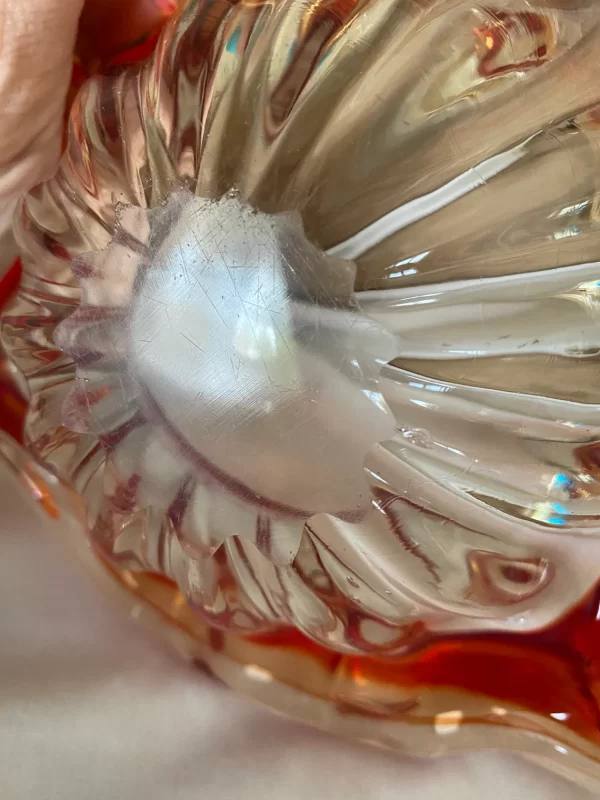 Red glass cigar ashtray closeup of bottom