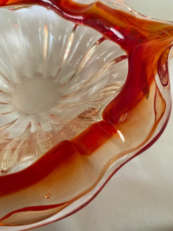 Red glass cigar ashtray closeup of side