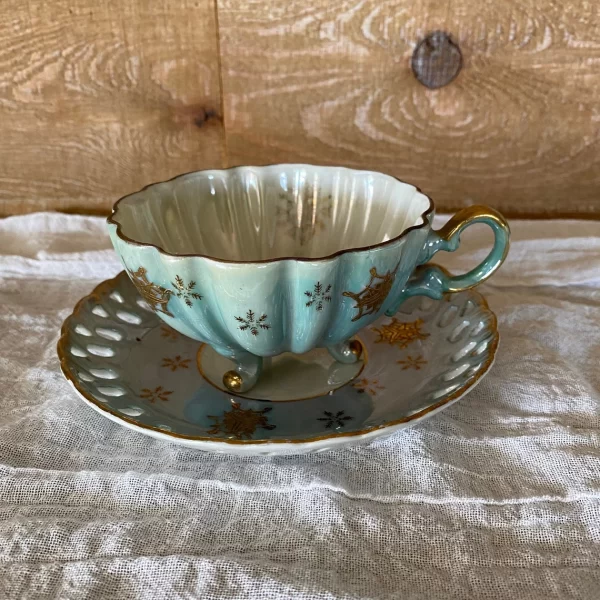 Lefton china hand painted tea cup and saucer blue with gold snowflakes closeup