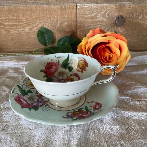 Paragon fine bone china tea cup and saucer with colorful flowers on blue tea cup