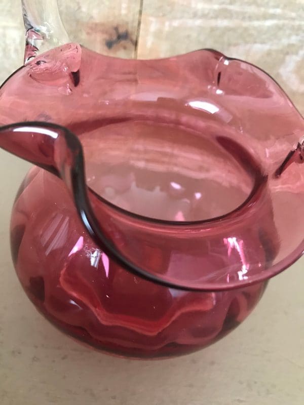 pink glass basket clear glass handle close edge