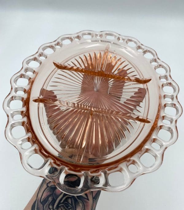 pink depression glass platter in hand to show size