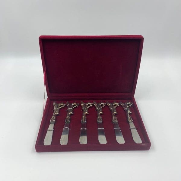 Christmas butter knives set of six in red velvet case handles all have different reindeer name embossed into them and each handle is shaped like a reindeer