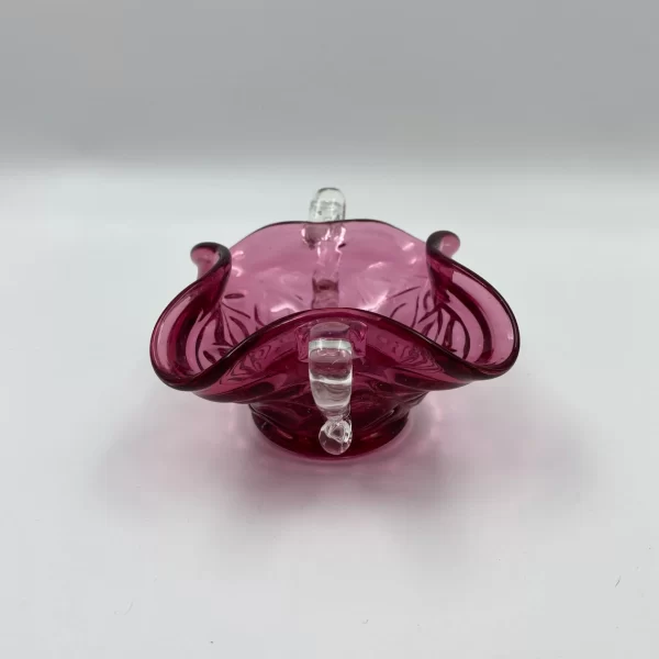 pink glass bowl side showing one of the clear glass handles