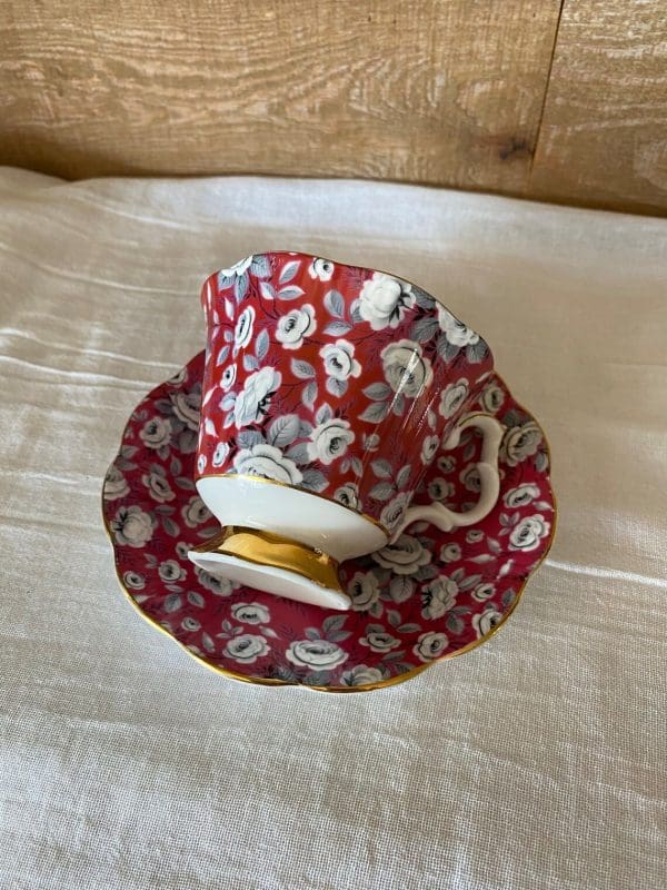 Royal Albert tea cup and saucer fuchsia and grey silver chintz pattern tea cup atop saucer on sude