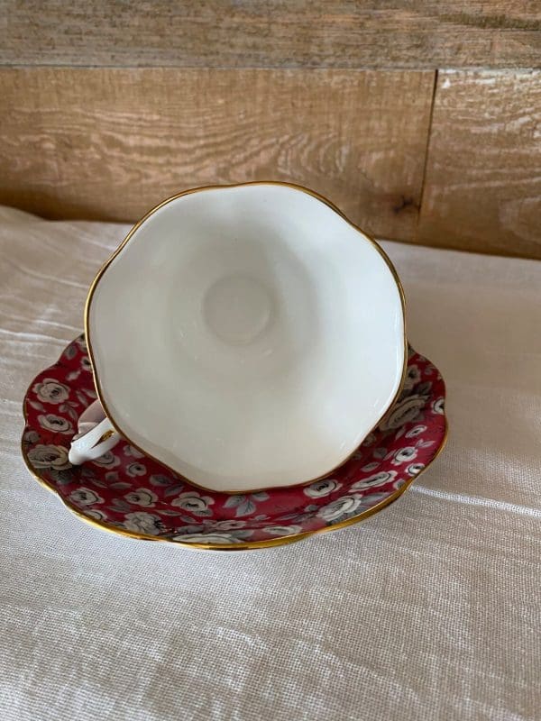 Royal Albert tea cup and saucer fuchsia and grey silver chintz pattern. View showing white inside of tea cup and gold rim on trim